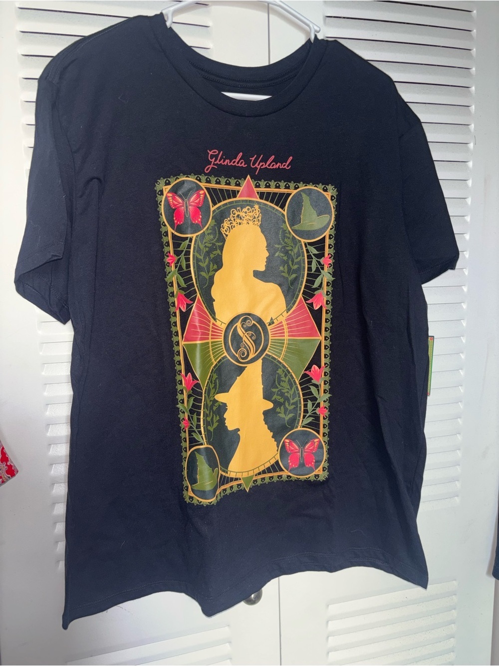Glinda upland Graphic Tee with Gold Silhouette and Red Accents